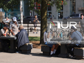 People play chess at Nathan Philips Square in downtown Toronto, Ontario, Canada, on August 14, 2024. (