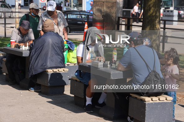 People play chess at Nathan Philips Square in downtown Toronto, Ontario, Canada, on August 14, 2024. 