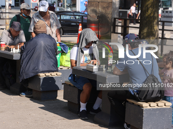 People play chess at Nathan Philips Square in downtown Toronto, Ontario, Canada, on August 14, 2024. (