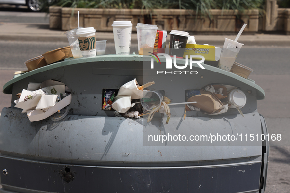 An overflowing garage can in Toronto, Ontario, Canada, on August 24, 2024. 