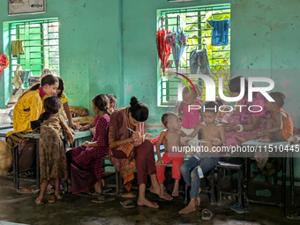 Children take shelter in a primary school during a flood in Feni, Bangladesh, on August 25, 2024. (