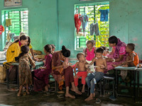 Children take shelter in a primary school during a flood in Feni, Bangladesh, on August 25, 2024. (