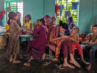 Children take shelter in a primary school during a flood in Feni, Bangladesh, on August 25, 2024. (