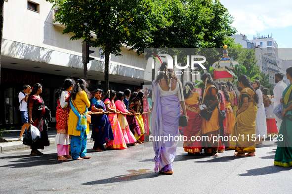 Women pull a chariot during the Ganesh Chaturthi procession, in Paris, France, on August 25, 2024.  