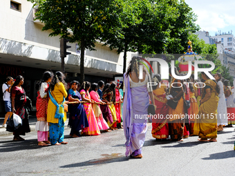 Women pull a chariot during the Ganesh Chaturthi procession, in Paris, France, on August 25, 2024.  (