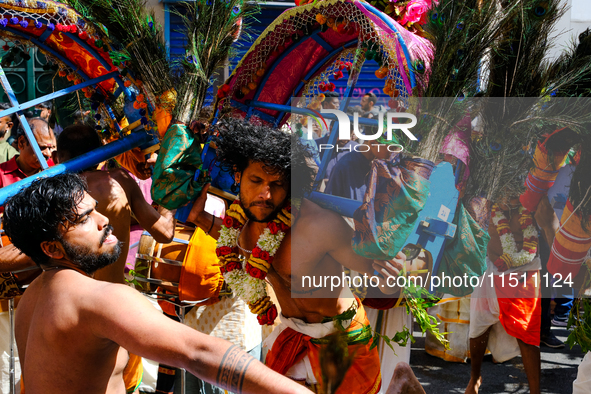 Dancers wearing peacock feathers perform during Ganesh Chaturthi, the annual Hindu celebration, in the streets of Paris, France, in Paris, F...