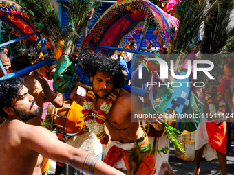 Dancers wearing peacock feathers perform during Ganesh Chaturthi, the annual Hindu celebration, in the streets of Paris, France, in Paris, F...