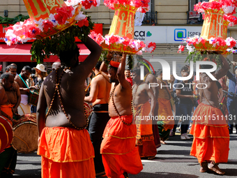 Hindus dance during Ganesh Chaturthi in the streets of Paris, France, in Paris, France, on August 25, 2024.  (