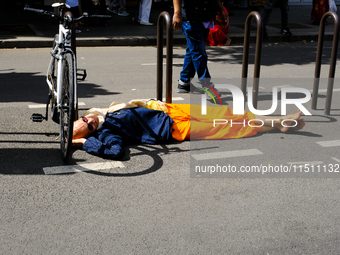 A Hare Krishna devotee sleeps on the road during the 27th Ganesh festival in Paris, France, on September 1, 2019, in Paris, France, on Augus...