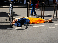 A Hare Krishna devotee sleeps on the road during the 27th Ganesh festival in Paris, France, on September 1, 2019, in Paris, France, on Augus...