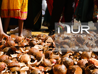 People participate in the Ganesh Chaturthi procession and walk past coconuts during the 27th Ganesh festival in Paris, France, on September...