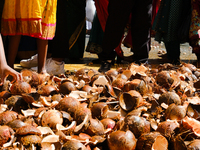 People participate in the Ganesh Chaturthi procession and walk past coconuts during the 27th Ganesh festival in Paris, France, on September...