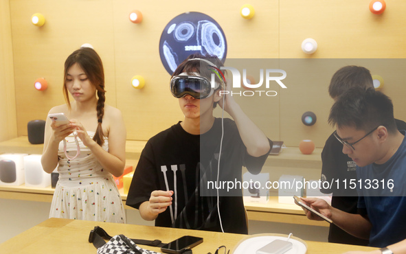 Students experience the Apple Vision Pro inside the flagship Apple store in Shanghai, China, on August 22, 2024. 