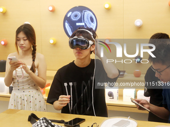 Students experience the Apple Vision Pro inside the flagship Apple store in Shanghai, China, on August 22, 2024. (