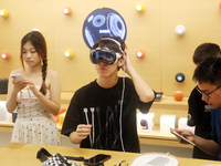 Students experience the Apple Vision Pro inside the flagship Apple store in Shanghai, China, on August 22, 2024. (