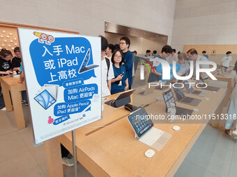 Students experience Apple products at the Apple flagship store in Shanghai, China, on August 22, 2024. (