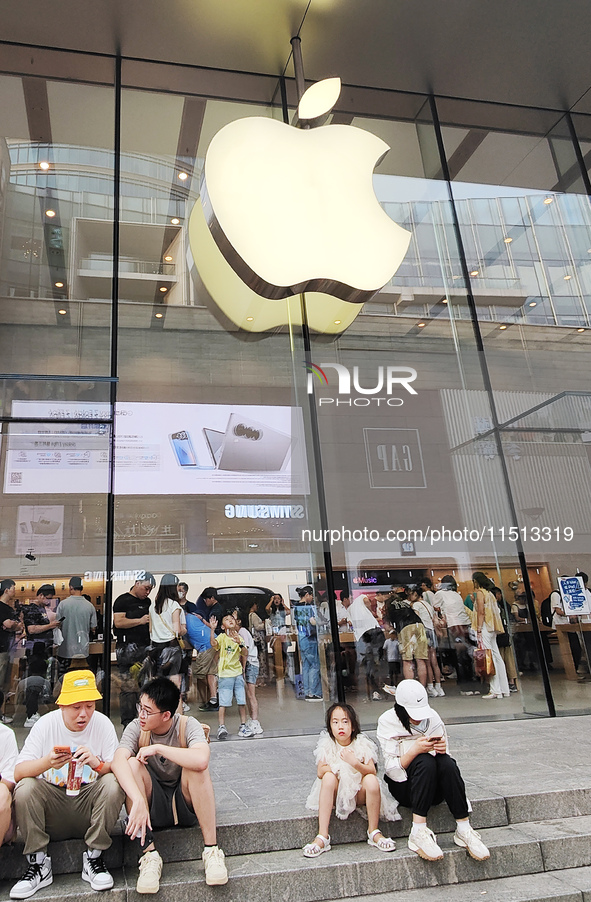 Students experience Apple products at the Apple flagship store in Shanghai, China, on August 22, 2024. 