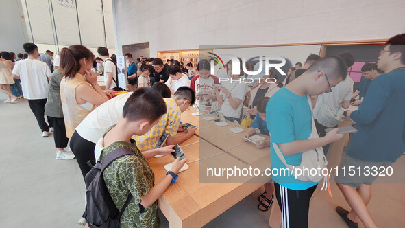 Students experience Apple products at the Apple flagship store in Shanghai, China, on August 22, 2024. 