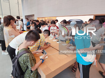 Students experience Apple products at the Apple flagship store in Shanghai, China, on August 22, 2024. (