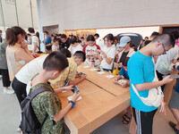 Students experience Apple products at the Apple flagship store in Shanghai, China, on August 22, 2024. (