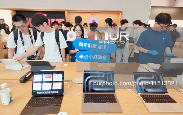 Students experience Apple products at the Apple flagship store in Shanghai, China, on August 22, 2024. 