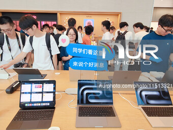 Students experience Apple products at the Apple flagship store in Shanghai, China, on August 22, 2024. (