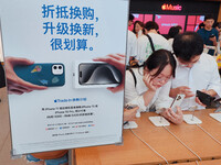 Students experience Apple products at the Apple flagship store in Shanghai, China, on August 22, 2024. (