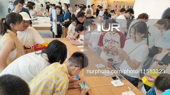 Students experience Apple products at the Apple flagship store in Shanghai, China, on August 22, 2024. 