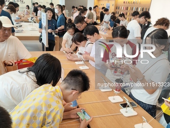 Students experience Apple products at the Apple flagship store in Shanghai, China, on August 22, 2024. (