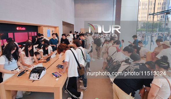 Students experience Apple products at the Apple flagship store in Shanghai, China, on August 22, 2024. 