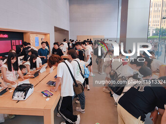 Students experience Apple products at the Apple flagship store in Shanghai, China, on August 22, 2024. (