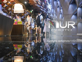 People read at Zhongshuge Bookstore in Guiyang, China, on August 18, 2024. (