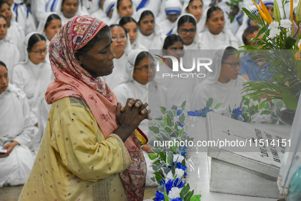 A lady prays in front of Saint Teresa's tomb on the occasion of Saint Teresa's birthday at Mother House in Kolkata, India, on August 26, 202...