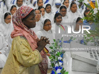 A lady prays in front of Saint Teresa's tomb on the occasion of Saint Teresa's birthday at Mother House in Kolkata, India, on August 26, 202...