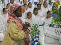 A lady prays in front of Saint Teresa's tomb on the occasion of Saint Teresa's birthday at Mother House in Kolkata, India, on August 26, 202...