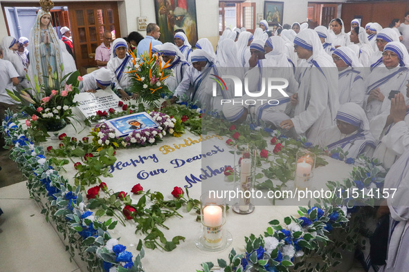 Sisters of Missionaries of Charity pray in front of Saint Teresa's tomb on the occasion of Saint Teresa's birthday at Mother House in Kolkat...