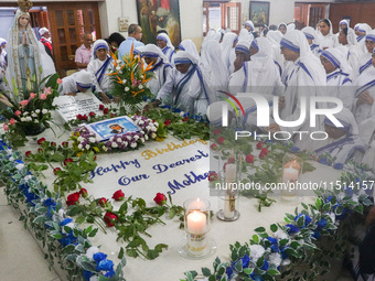 Sisters of Missionaries of Charity pray in front of Saint Teresa's tomb on the occasion of Saint Teresa's birthday at Mother House in Kolkat...