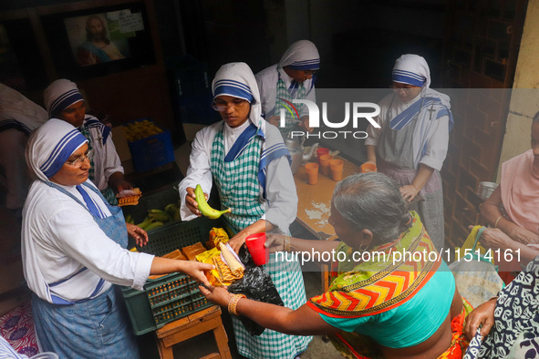 Sisters of Missionaries of Charity provide free food to the needy on the occasion of Saint Teresa's birthday at Mother House in Kolkata, Ind...