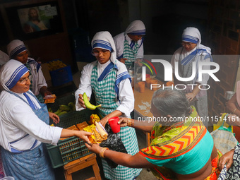 Sisters of Missionaries of Charity provide free food to the needy on the occasion of Saint Teresa's birthday at Mother House in Kolkata, Ind...