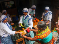 Sisters of Missionaries of Charity provide free food to the needy on the occasion of Saint Teresa's birthday at Mother House in Kolkata, Ind...