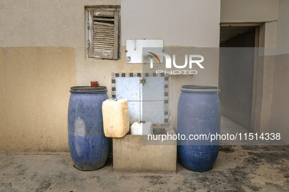 Plastic jerry cans and barrels are filled with drinking water in a house in a rural area in Kairouan, Tunisia, on May 8, 2024. As the region...