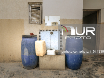 Plastic jerry cans and barrels are filled with drinking water in a house in a rural area in Kairouan, Tunisia, on May 8, 2024. As the region...