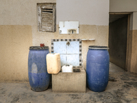 Plastic jerry cans and barrels are filled with drinking water in a house in a rural area in Kairouan, Tunisia, on May 8, 2024. As the region...