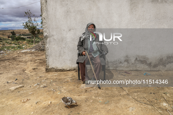 An old Tunisian man poses for photos in a rural area in Kairouan, Tunisia, on May 8, 2024. 