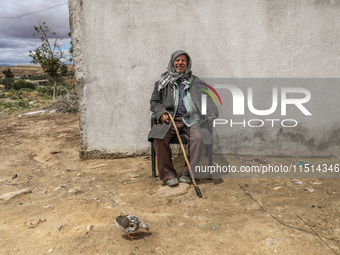 An old Tunisian man poses for photos in a rural area in Kairouan, Tunisia, on May 8, 2024. (