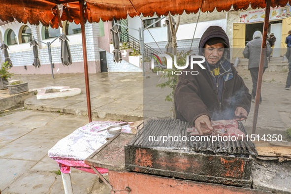 A street vendor grills meat on a barbecue in Siliana, Tunisia, on May 9, 2024. Due to unemployment, young Tunisians try to find a way to sup...