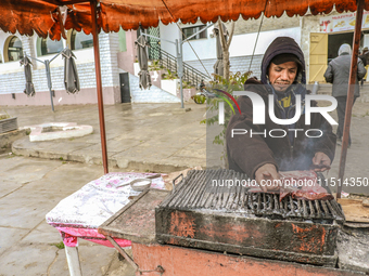 A street vendor grills meat on a barbecue in Siliana, Tunisia, on May 9, 2024. Due to unemployment, young Tunisians try to find a way to sup...