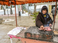 A street vendor grills meat on a barbecue in Siliana, Tunisia, on May 9, 2024. Due to unemployment, young Tunisians try to find a way to sup...