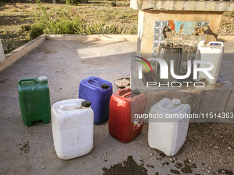 Plastic cans filled with water at a drinking water point in the isolated rural area of Chrichira located in Kairouan, Tunisia, on May 8, 202...