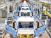 Workers work on an automobile production line at BYD Industrial Co LTD in Huai'an, China, on August 26, 2024. (